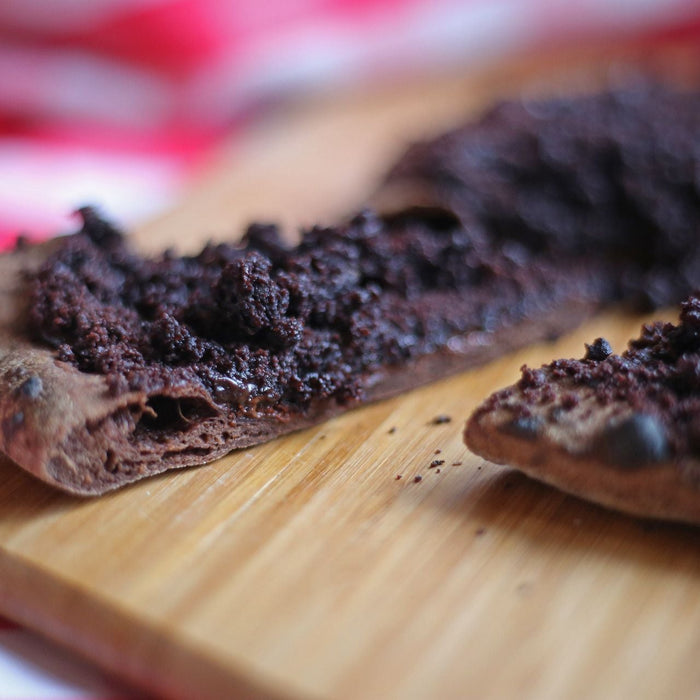 Chocolate covered pizza on a wooden pizza peel
