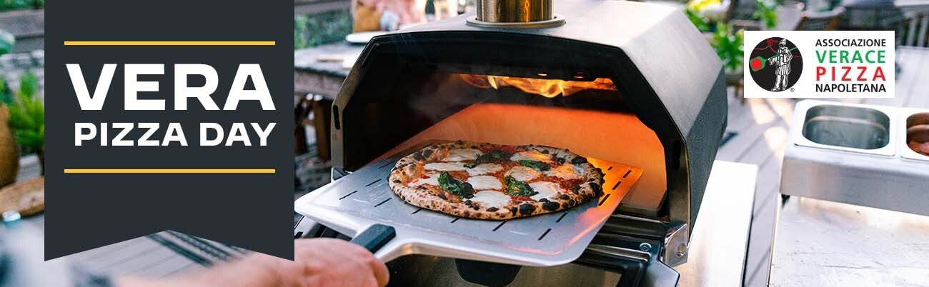 A pizza on a pizza peel being put into an Ooni Karu 16 pizza oven