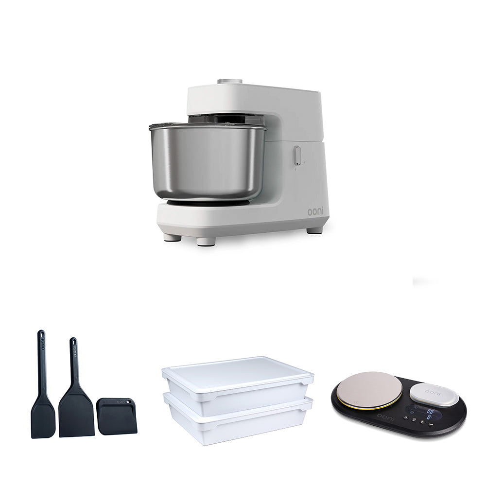 A white stand mixer with a stainless steel bowl is shown above three smaller accessories on a white background: two black spatulas, two white plastic storage containers, and a black digital scale. #variant-2