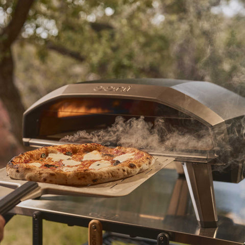 retrieving pizza from Ooni Koda 2 Max Pizza Oven