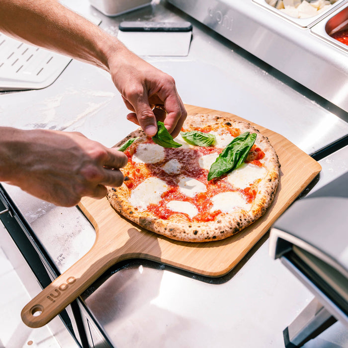 Ooni 12″ Bamboo Pizza Peel & Serving Board | Click this image to open up the product gallery modal. The product gallery modal allows the images to be zoomed in on.